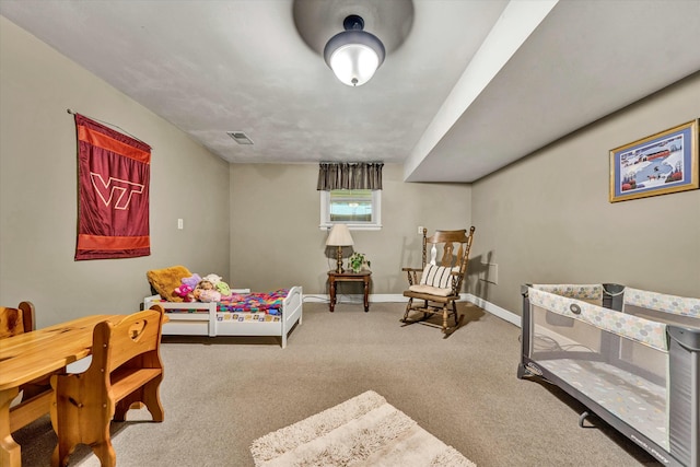 carpeted bedroom with visible vents and baseboards