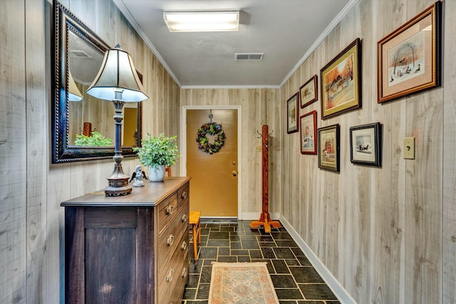 foyer with visible vents, stone finish flooring, baseboards, and ornamental molding