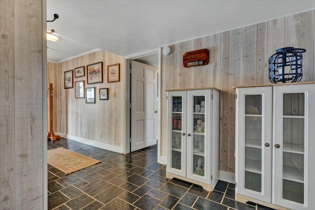 bathroom featuring french doors, baseboards, and stone finish flooring