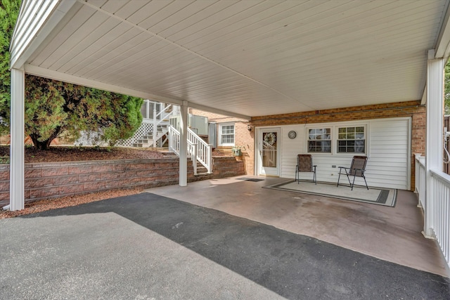 view of patio featuring stairway and a carport