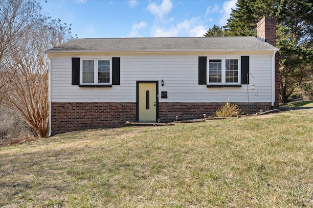 split foyer home with a chimney and a front lawn