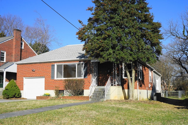 view of front facade with driveway, central AC, a front lawn, a garage, and brick siding