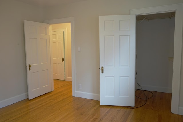 unfurnished bedroom featuring baseboards and light wood-style flooring