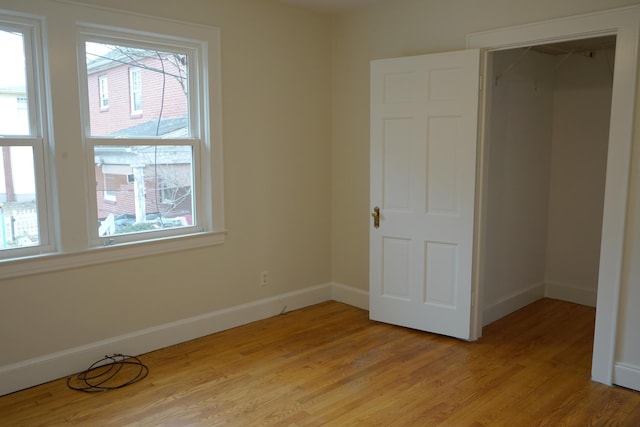 unfurnished bedroom with light wood-type flooring and baseboards