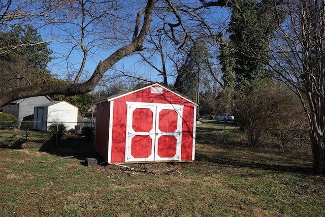 view of shed featuring fence