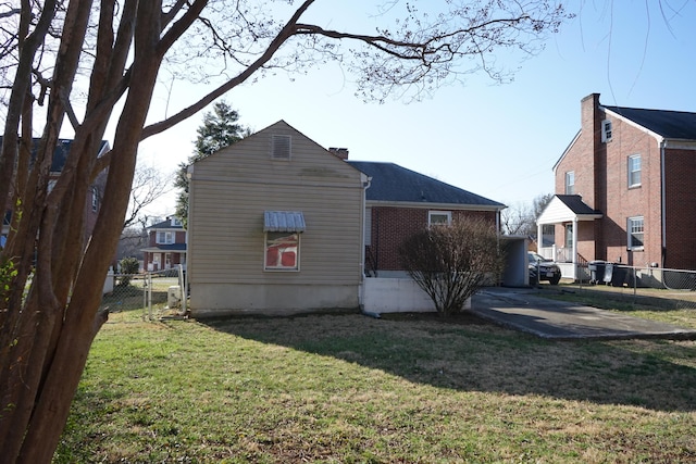 view of side of property with a yard and fence