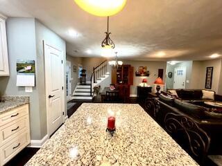 interior space featuring stairs and baseboards