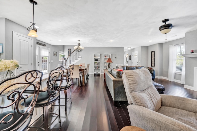 living room featuring dark wood finished floors, baseboards, a chandelier, and recessed lighting