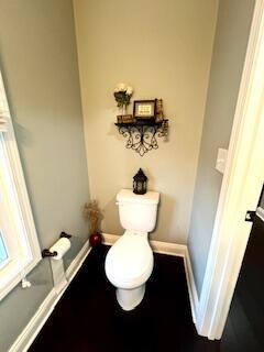 bathroom with toilet and baseboards