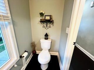 bathroom with toilet and baseboards