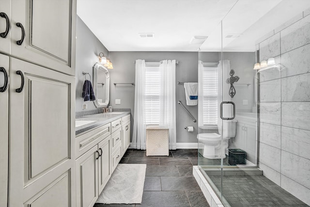 bathroom with double vanity, visible vents, a sink, baseboards, and a stall shower