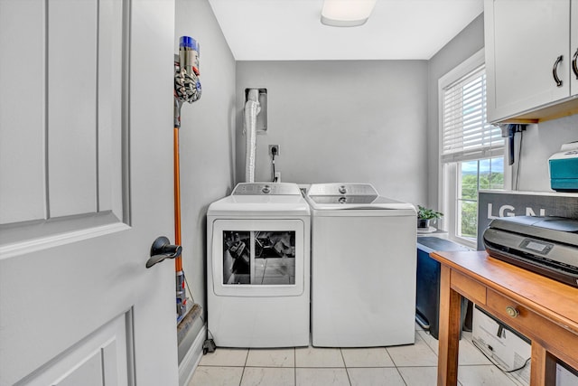 laundry area with washing machine and clothes dryer and cabinet space