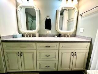 bathroom with a shower with shower curtain, double vanity, and a sink