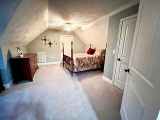 bedroom with baseboards, lofted ceiling, and carpet