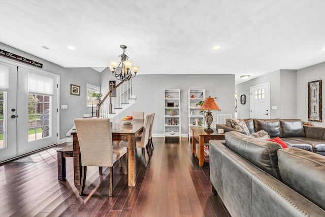 dining space with recessed lighting, stairway, dark wood-style flooring, and a notable chandelier