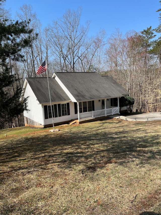 view of front of home featuring a front yard, crawl space, covered porch, and a shingled roof