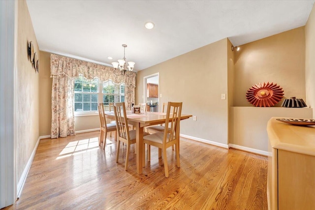 dining room featuring recessed lighting, baseboards, a notable chandelier, and light wood finished floors