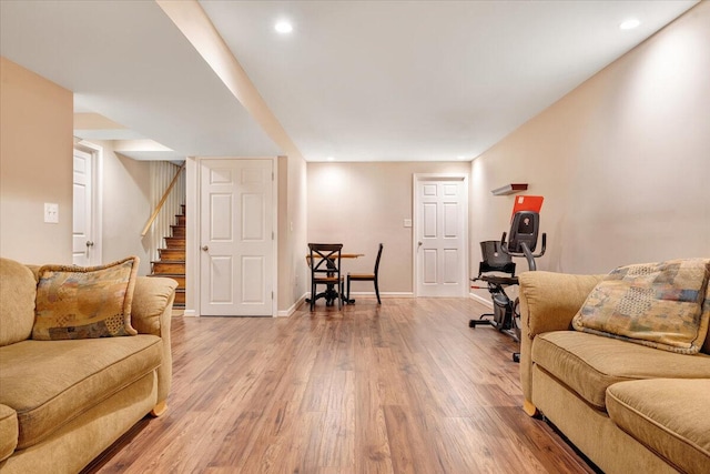 living room with recessed lighting, stairway, light wood-style flooring, and baseboards