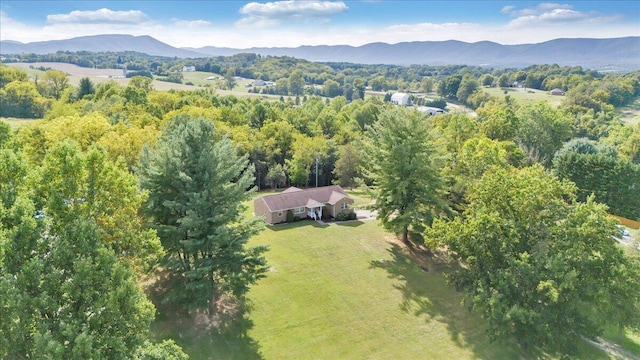 birds eye view of property with a forest view and a mountain view