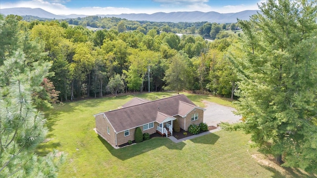 drone / aerial view with a mountain view and a wooded view