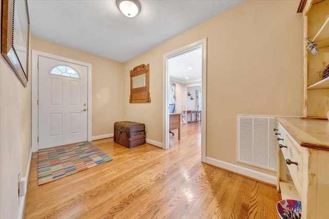 foyer with visible vents, light wood-type flooring, and baseboards