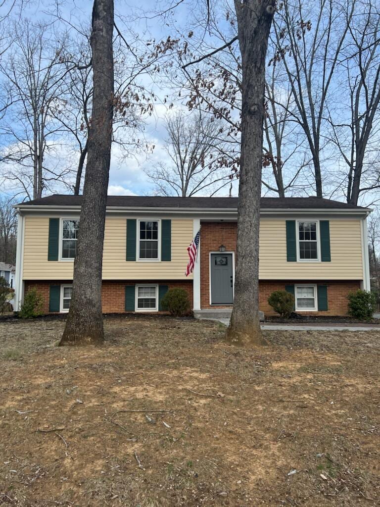 split foyer home featuring brick siding