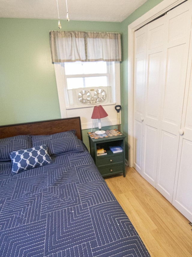 bedroom featuring a closet and light wood finished floors