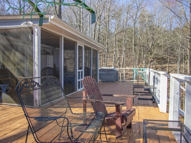 wooden deck featuring a sunroom and grilling area