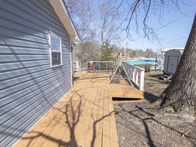 view of yard with a deck, a storage shed, and an outdoor structure