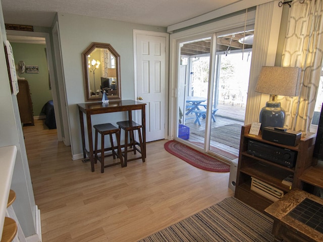 doorway to outside with light wood finished floors