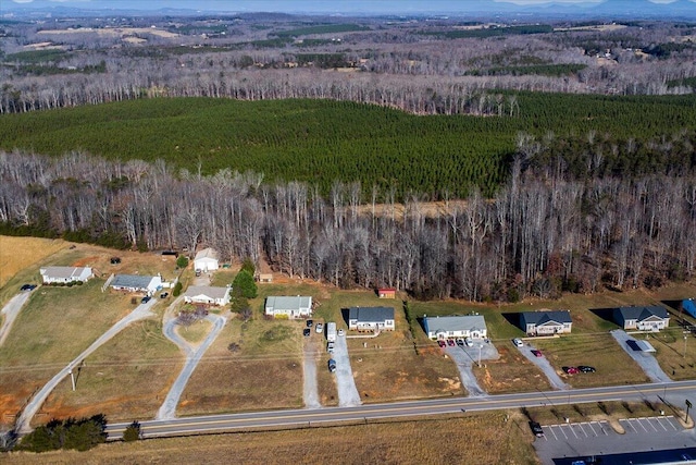 birds eye view of property featuring a wooded view