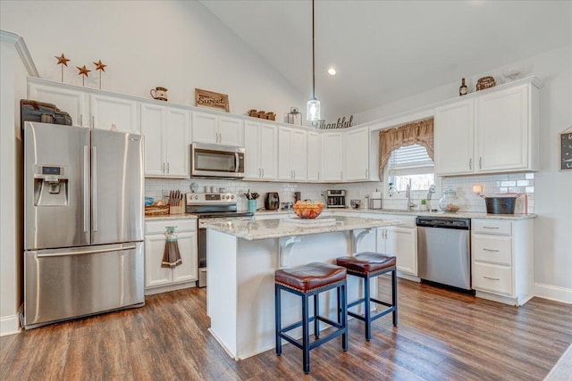 kitchen featuring a center island, appliances with stainless steel finishes, white cabinetry, and dark wood-style flooring