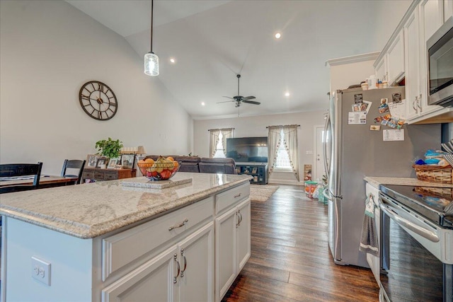 kitchen featuring dark wood-type flooring, a ceiling fan, a kitchen island, white cabinetry, and stainless steel appliances