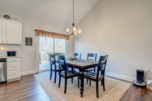 dining room with an inviting chandelier, wood finished floors, baseboards, and high vaulted ceiling