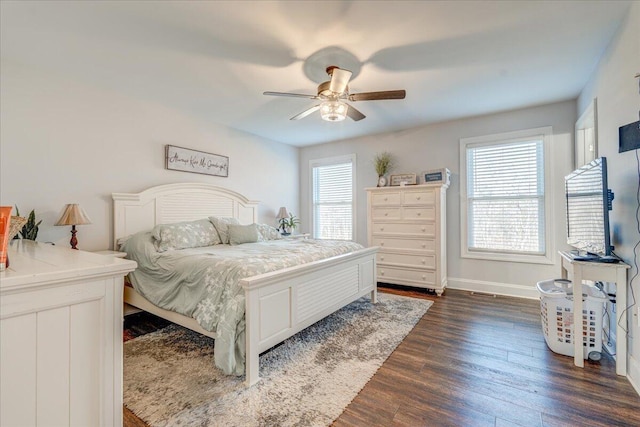 bedroom featuring ceiling fan, baseboards, and dark wood-style floors