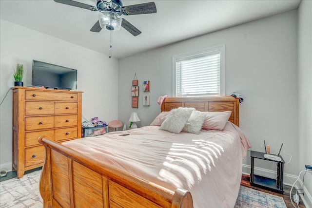 bedroom featuring baseboards and ceiling fan