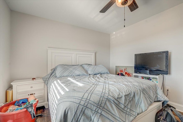 bedroom featuring a ceiling fan, wood finished floors, and baseboards