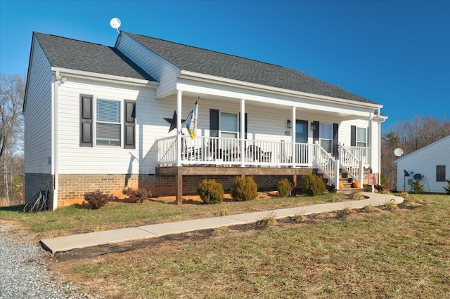 view of front of house with covered porch and roof with shingles