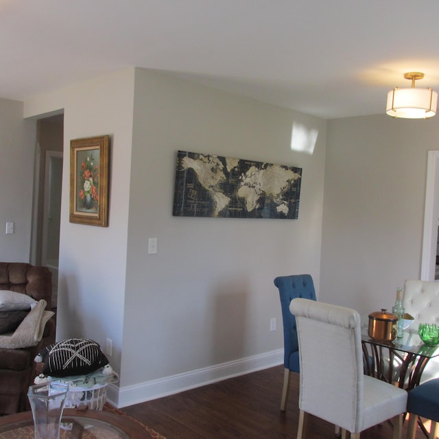 dining area with baseboards and wood finished floors