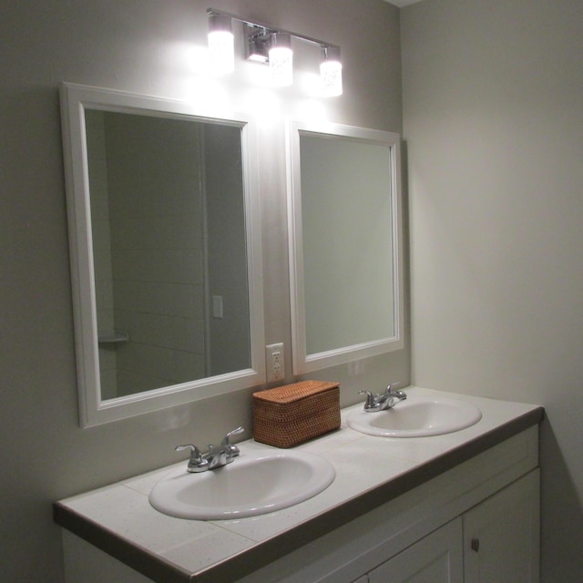 full bathroom featuring double vanity and a sink