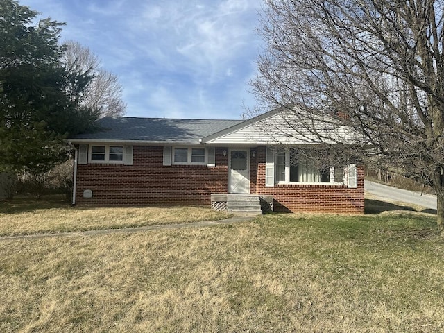 ranch-style house with brick siding and a front lawn