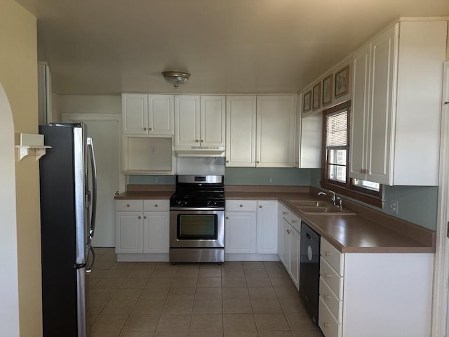 kitchen featuring a sink, under cabinet range hood, white cabinetry, appliances with stainless steel finishes, and light tile patterned floors