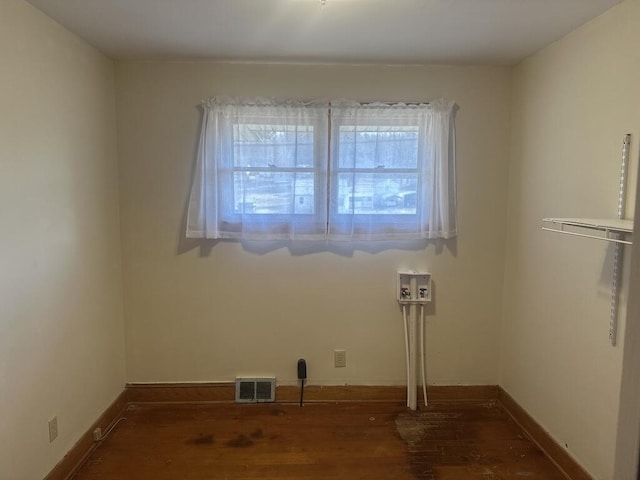 empty room featuring visible vents and baseboards