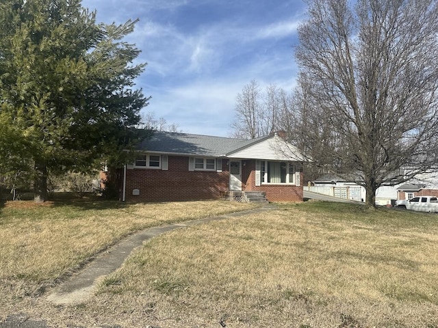 view of front of house with a front yard and brick siding