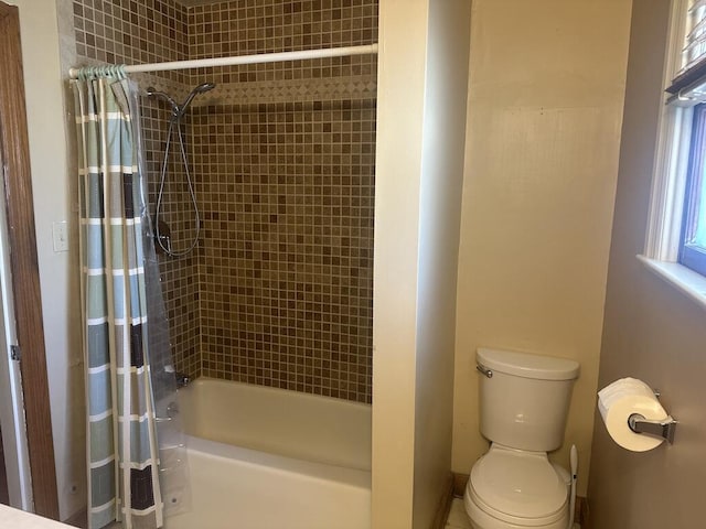 full bathroom featuring shower / tub combo and toilet