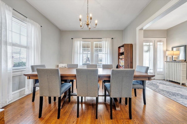 dining room with a notable chandelier and wood finished floors