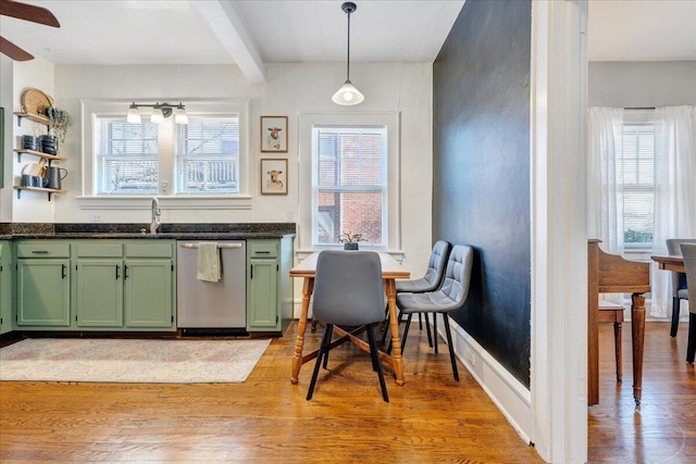 kitchen with a healthy amount of sunlight, light wood finished floors, dishwasher, green cabinets, and dark countertops