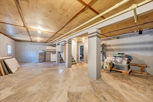 basement with stairway and washer / dryer