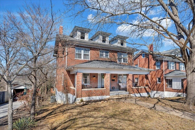 traditional style home with brick siding and a chimney