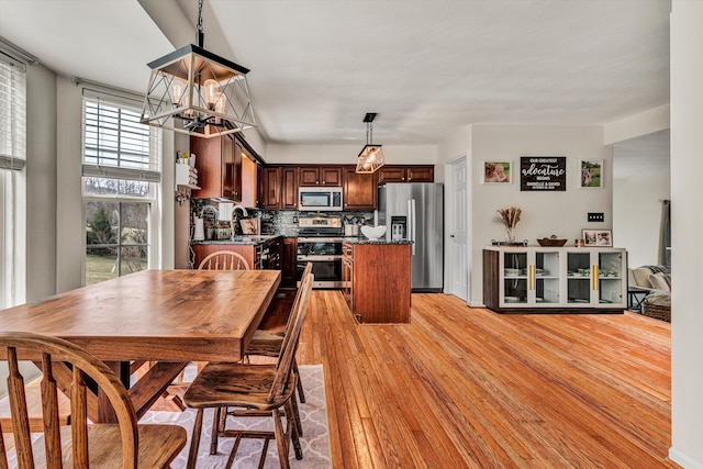 dining space with an inviting chandelier and light wood-style floors